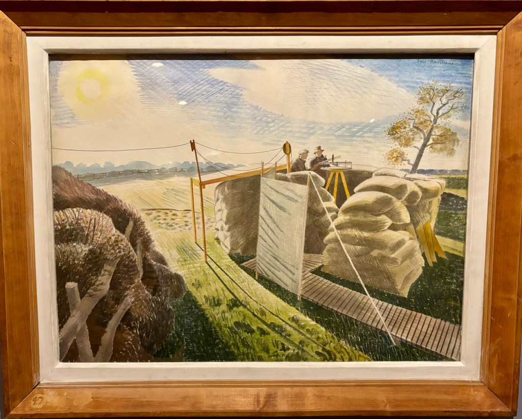 A water collur of sandbags and strong with observer equipment on a tripod. Two men are at the tripod and there are fields and trees in the distance. 