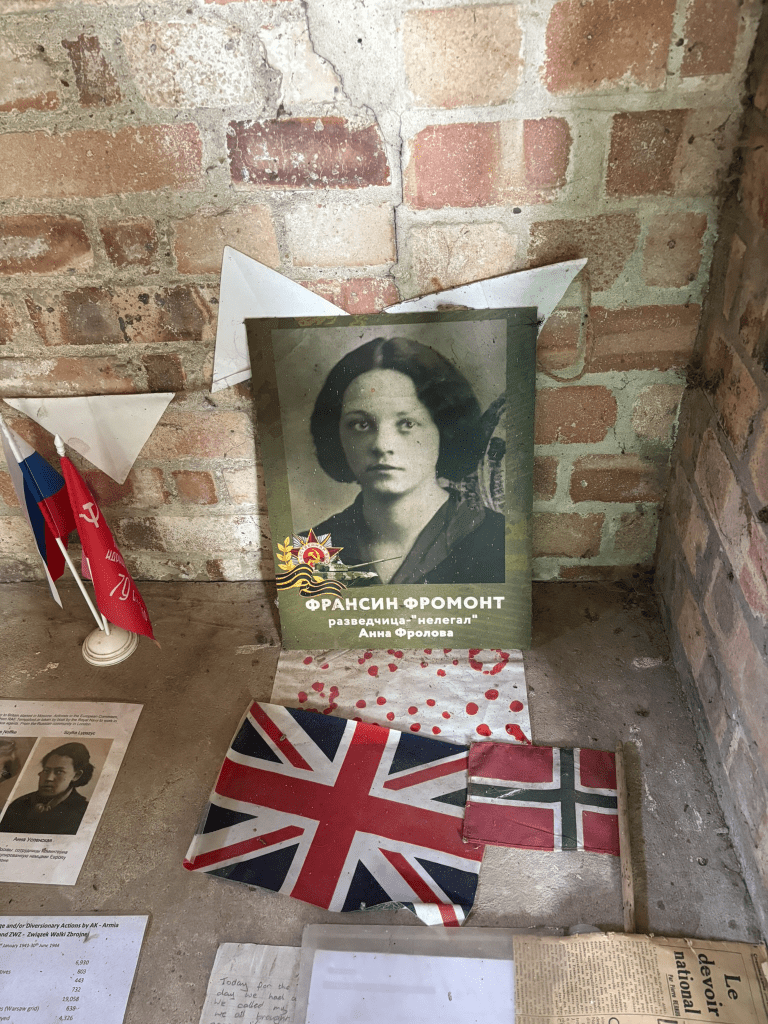 a photograph of a young woman below which is Cyrillic writing and union and Norwegian flags. There are news paper clippings and other bits of paper around too. 