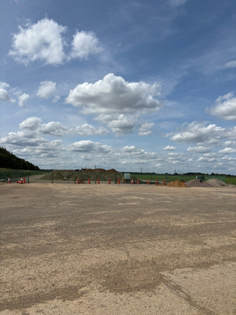 Wide concrete and expanse with fields in the distance 